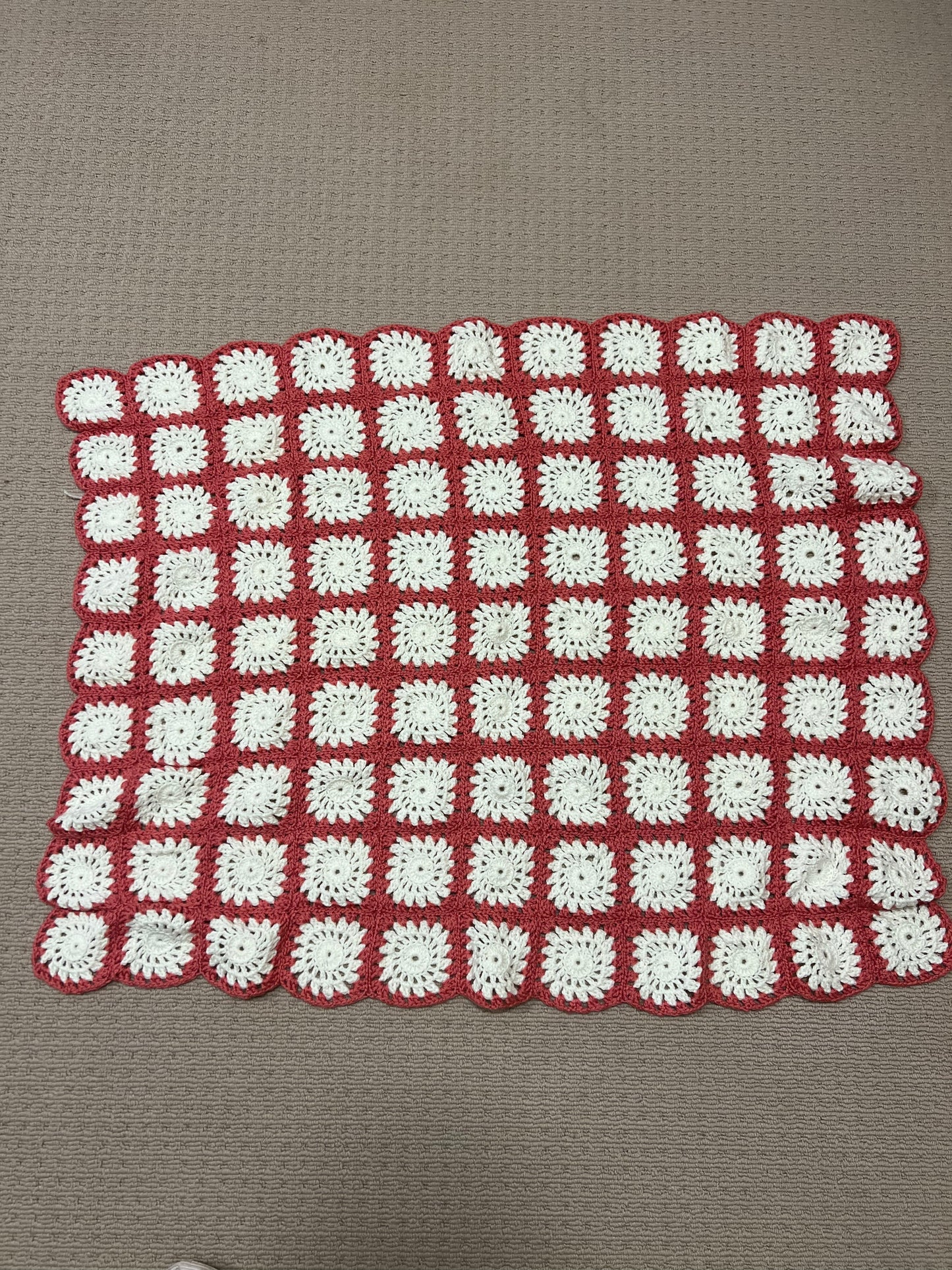 Pink and white granny square knee rug